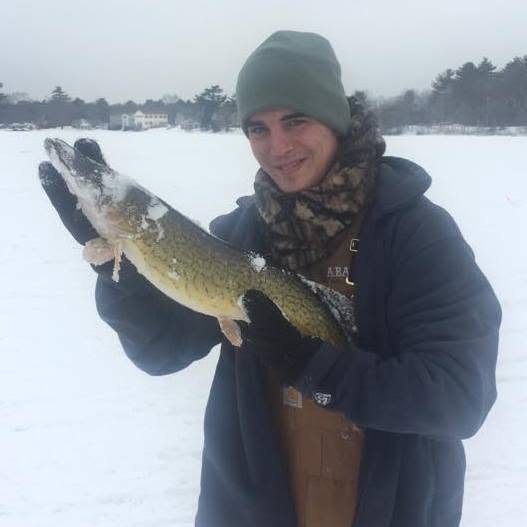 Paul holding a pickerel on the ice